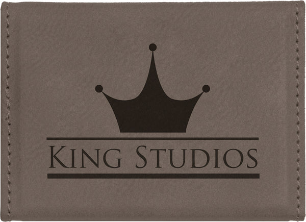 Grey leatherette magnetic business card holder engraved with a black company logo on the back.