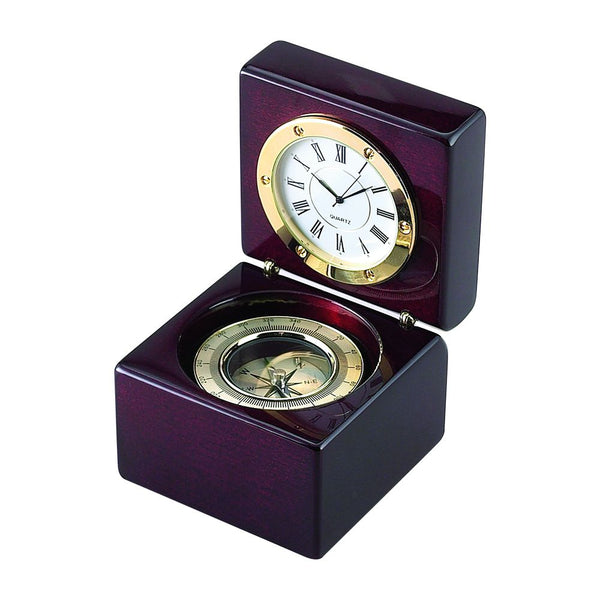 High gloss rosewood hinged box featuring a compass in the bottom half and a clock on  the top half when opened. The clock and compass are outlined in gold. The clock has a white face with black hands and roman numerals.
