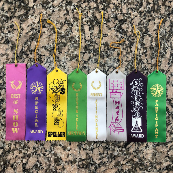 Eight different lapel ribbons all with different themes are displayed. Best of show, special award, spelling award, perfect attendance, math award, science award, and participation award.