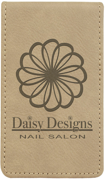 Tan rectangle shaped leatherette nail kit with silver zipper. The front is engraved with a company logo.