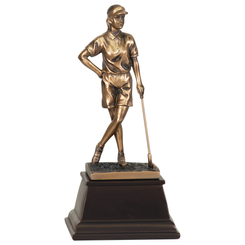 Medium sized bronze golf trophy on a tapered square dark wood base. The bronze female golfer is standing with her legs grossed and one hand on her hip and the other hand leaning on a golf club. She is staring off into the distance with a visor on.