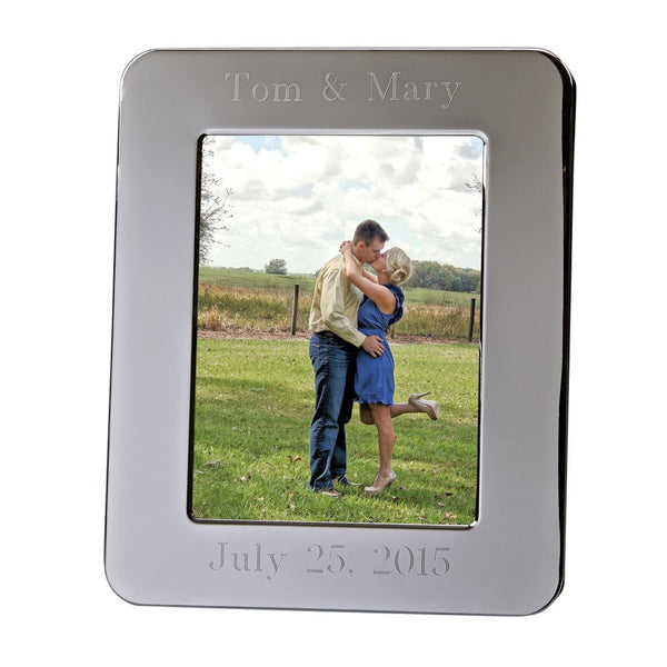 Shiny silver picture frame with rounded edges. Holds an 8" x 10" photo. The top of the picture frame is engraved to read "Tom & Mary". The bottom reads "July 25, 2015"