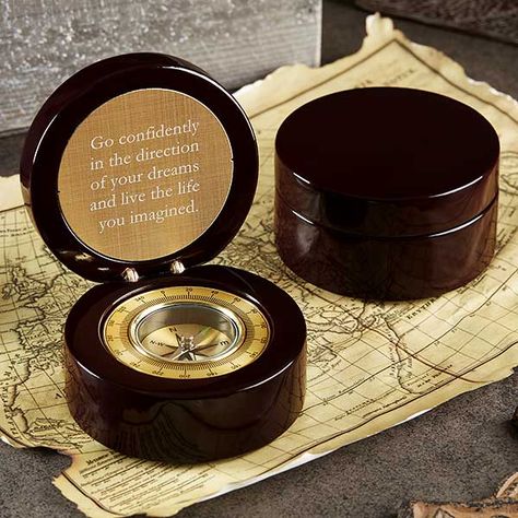 High gloss rosewood round hinged box with compass inside. Compass features a lid that opens up to display a gold plate engraved with a special message on top. The bottom half of the compass is a golden compass that matches the gold engraved plate.