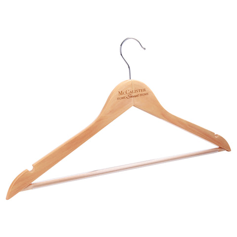 Wooden clothes hanger engraved with a name in a beautiful cursive font at the top.