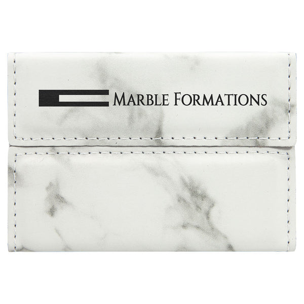 White and grey marble print business card holder engraved with a company logo in black.