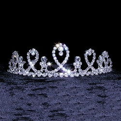 Small rhinestone tiara that resembles ribbon.