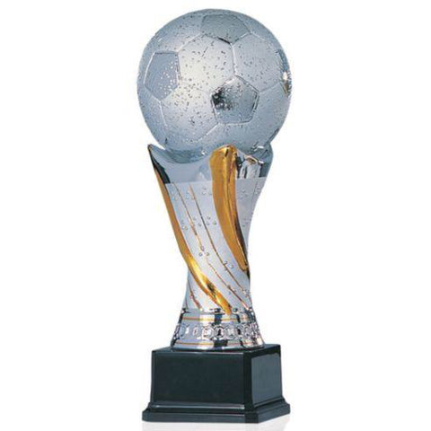 Large shiny silver ceramic trophy featuring a square black wood base, a gold and silver tall pedestal, and a huge silver soccer ball on top.