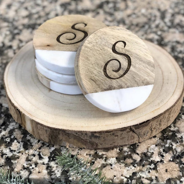 Set of four wood and marble engraved coasters. Coasters are 3/4 wood and 1/4 marble. Marble slab is at the bottom of each coaster. Coasters are engraved with a beautiful cursive "S".