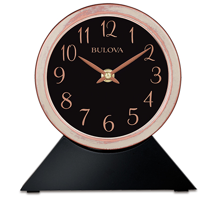 Black wood base with a detachable rose gold and white bushed clock sitting on top. Clock features a black face with rose gold numbers and hands. The rim of the clock is rose gold with an over bush of white for a rustic look.