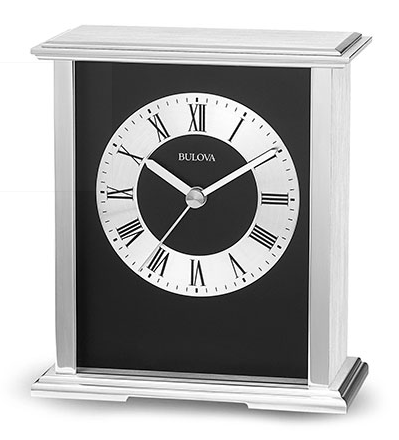 Silver metal Bulova clock featuring a rectangular construction, black inside, and a silver face with black roman numerals.