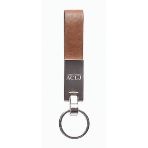 Brown leatherette loop keychain with a silver key ring and accent hooking the two together. The Silver rectangle accent is engraved with a scroll and a monogram.