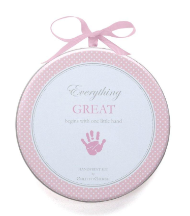 Round pink and white metal tin that contains a baby girl clay hand print kit.