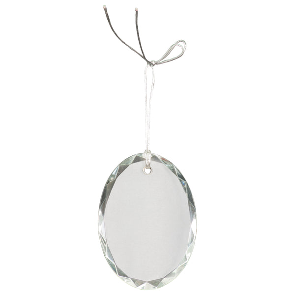 Oval shaped crystal ornament that is faceted on the sides and can be engraved in the center. A silver string is attached at the top for hanging.