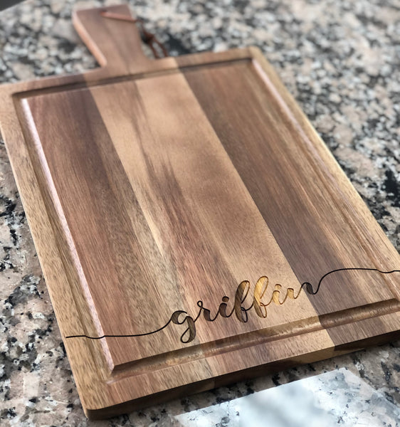 Custom engraved cutting board with handle.