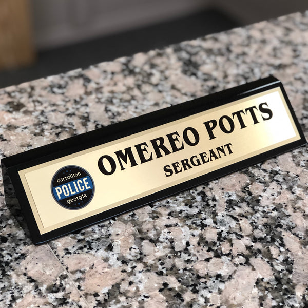 Personalized black and gold desk name plate.