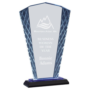 Tall blue glass award that is shaped like a handheld fan. The award sits on a black base with a blue reflection that shines throughout. The award is textured with a diamond pattern on the left and right edges and is engraved in a frosty white color.
