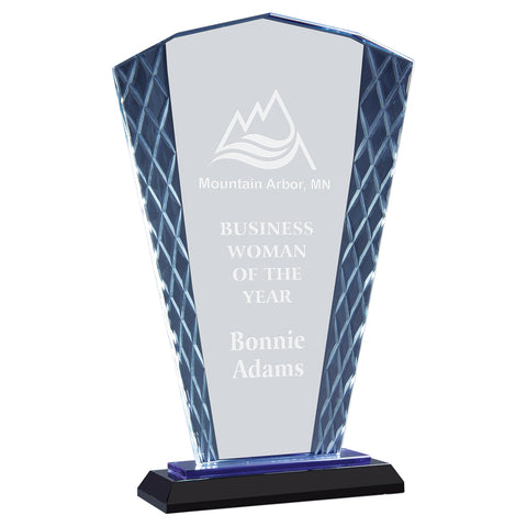Tall blue glass award that is shaped like a handheld fan. The award sits on a black base with a blue reflection that shines throughout. The award is textured with a diamond pattern on the left and right edges and is engraved in a frosty white color.
