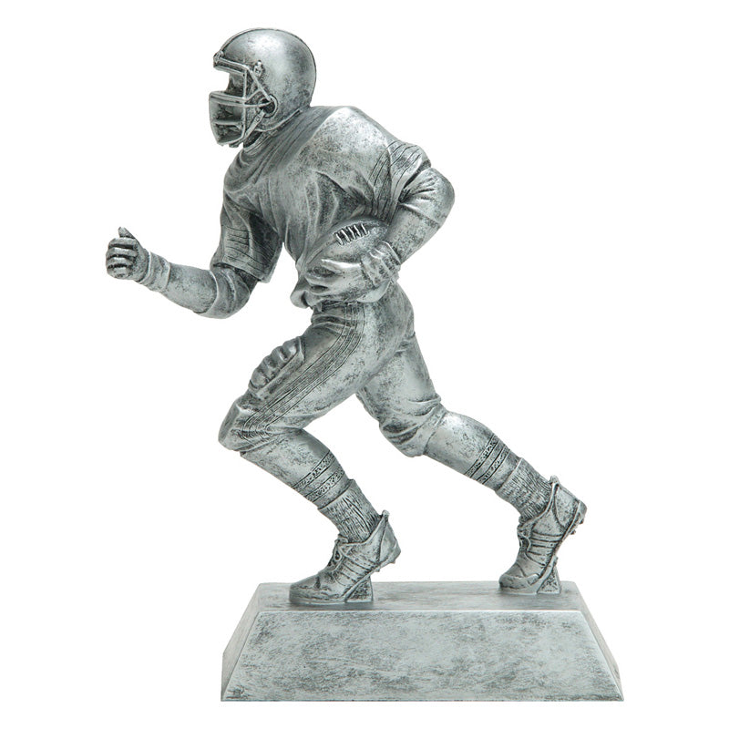 Silver football resin featuring a rectangle silver base and a silver football player running with a football tucked in one arm.