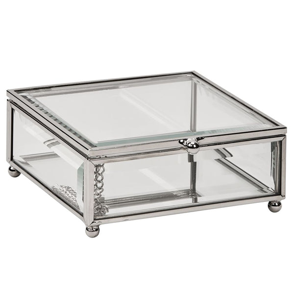 Rectangle shaped glass jewelry box with silver edges and corners and round feet.