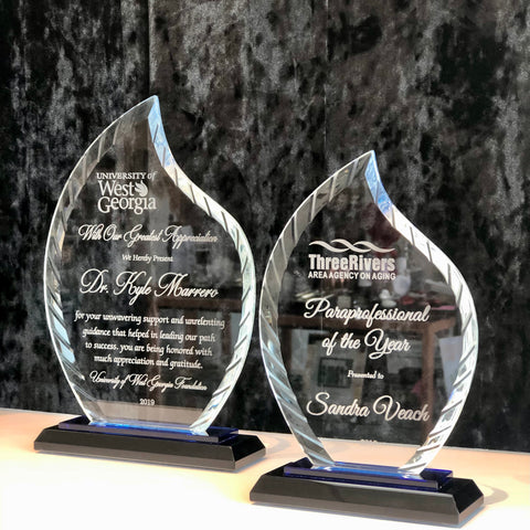 Custom engraved glass flame awards.