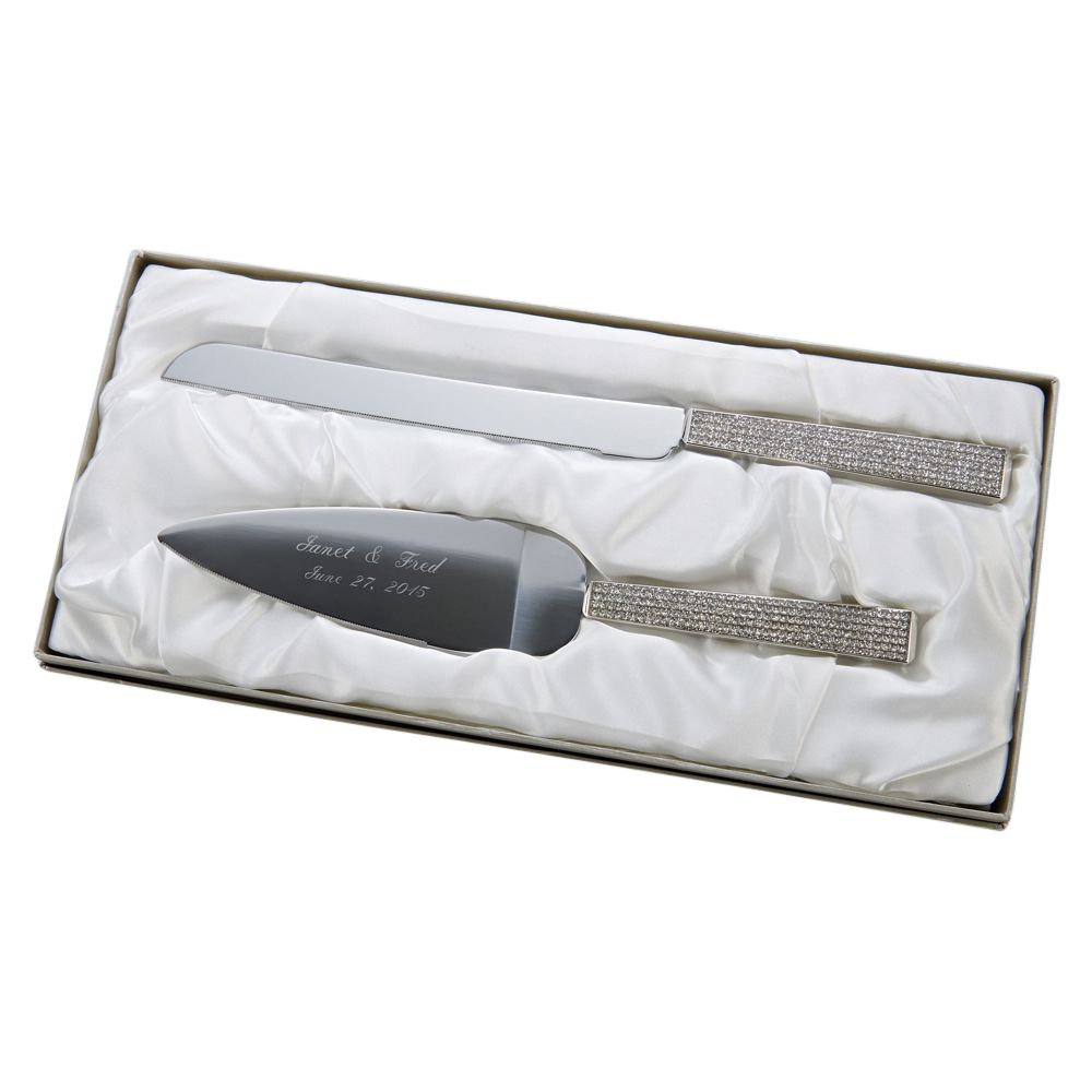 Shiny silver cake server and knife set featuring glitter handles and engraved with a two names and a wedding date in a beautiful cursive font.