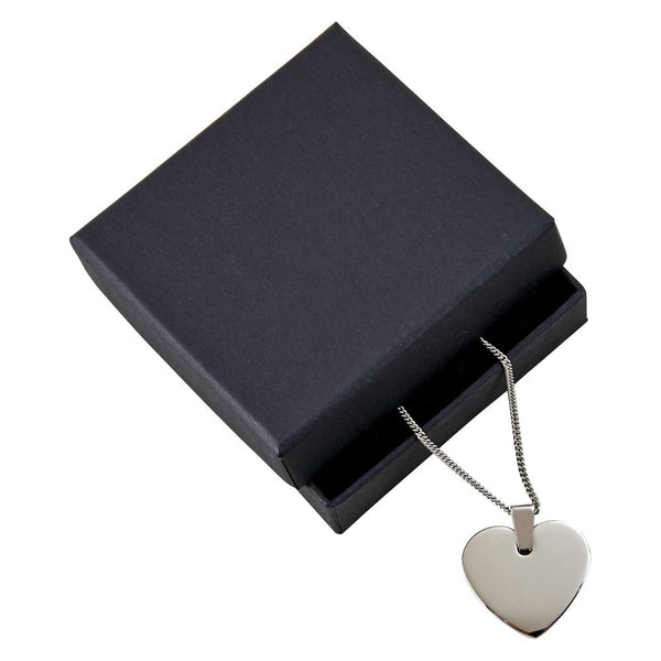 Engraved heart shaped silver necklace in black display box.