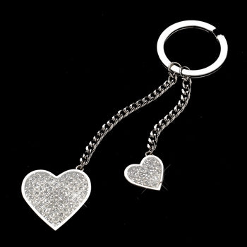 Silver keychain featuring two chains attached to the key ring. One is longer, one is shorter. At the end of each chain hangs a large glitter heart and a small glitter heart.