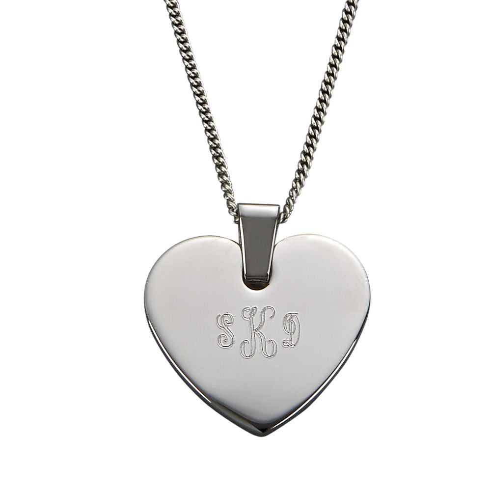 Monogrammed heart shaped silver necklace. Three letters are engraved in a beautiful cursive font.