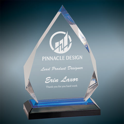 Clear engraved impress diamond shaped acrylic award on a black and blue base.