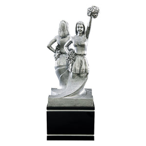Large black and silver cheerleading trophy featuring a black square wood base and two cheerleaders back to back perfoming different cheerleading tasks. One cheerleader has one hand on her hip and the other raised above her had with a pom pom. The opposite side displays a cheerleader with both hands on her hips.