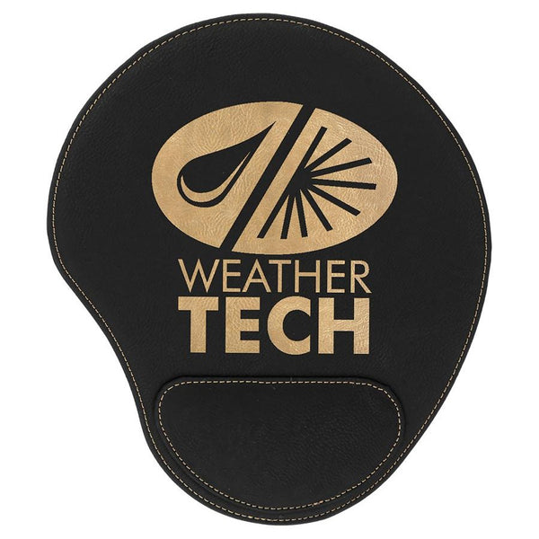 Black leatherette mouse pad with a pad at the bottom to rest your wrist. The mouse pad is engraved with a large gold company logo.