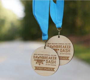 Large wood burned wooden medallions with light blue neck ribbons.