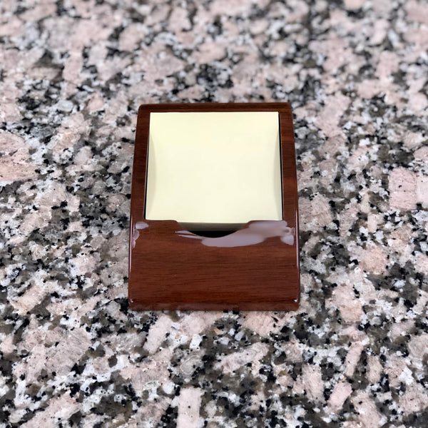 Piano finish memo holder featuring a curved edge where there is room for an engraved plate. A standard stack of yellow post it notes fits inside the memo holder.