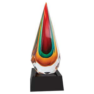 Art glass award featuring a colorful teardrop shape and a square black base. Teardrop is faceted on all sides and pointed at the top. Tear drop is clear, mustard, turquoise, and burgundy colored.