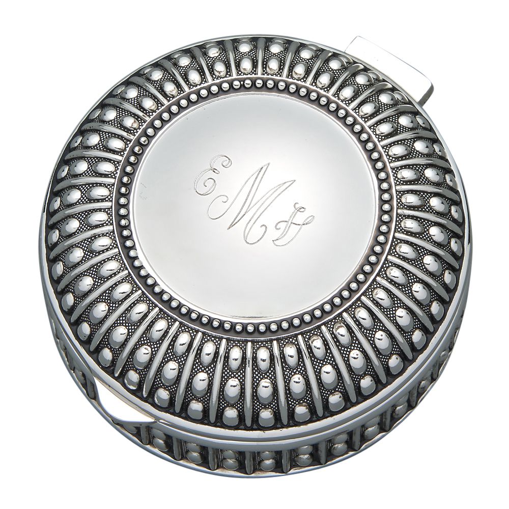Round jewelry box with hinged lid and a beaded design. The top features a silver circle with a flat area for engraving. The top is engraved with a monogram in a cursive font.