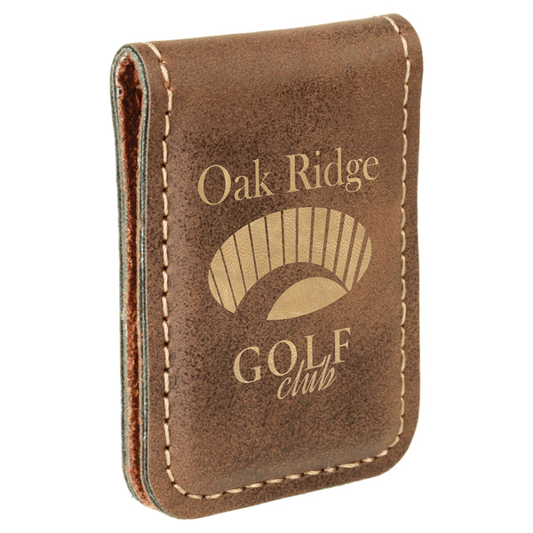 Brown rustic rectangular shaped magnetic money clip. The front of the money clip is engraved with a gold company logo.