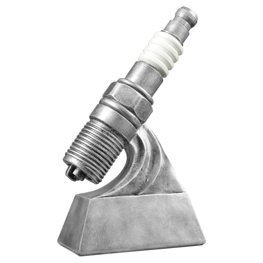 Car show trophy featuring a silver base and a large silver and white spark plug sitting on top.