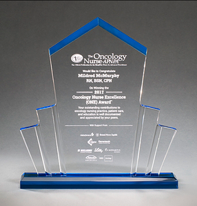 Large spotlight shaped acrylic award with a pointed top and a blue base that shines throughout.