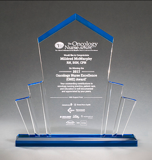 Large spotlight shaped acrylic award with a pointed top and a blue base that shines throughout.