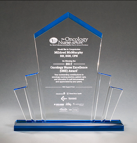 Large spotlight shaped acrylic award with a pointed top and a blue base that shines throughout.