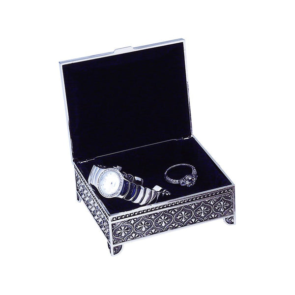 Square shaped silver jewelry box with an ornate feminine design on the sides and top. The hinged box is open and has a blue velvet lining with a ring and watch inside.