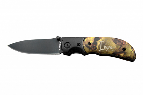 Large tactical camouflage knife featuring a handle with a realtree type design and an engraved name. The top of the knife is black and extends to a black blade.