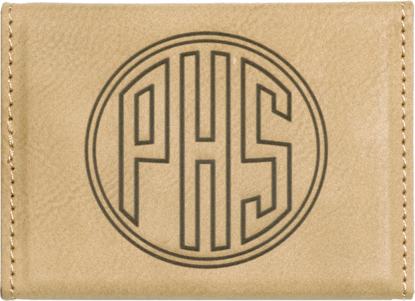 Tan leatherette business card holder engraved with a monogram on the back.
